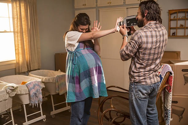 Image from "This is Us," in which Becca is Pregnant with twins and Jack takes a video of them in the nursery room. 