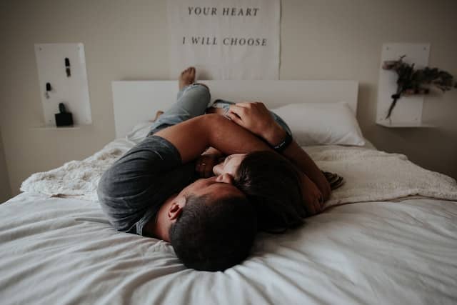 Couple lying and hugging on the bed
